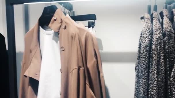 Stilvolle Kleidung in Boutiquen, modernes Ladeninterieur, Luxuseinkäufe und Modekollektion — Stockvideo