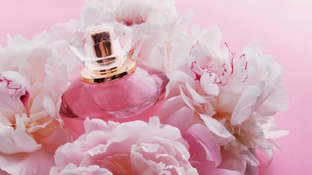 Frasco de perfume rosa con flores de peonía, aroma de fragancia elegante como cosmético de lujo, moda y fondo de producto de belleza — Vídeos de Stock