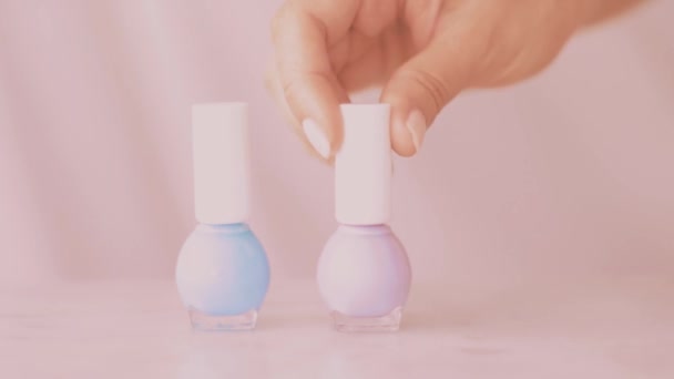 Pink beauty product scene, female hands and nailpolish bottles for french manicure, colourful pastel nail polish on marble table, make-up and cosmetic brand — Stock Video