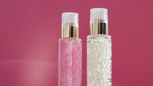 Luxury skincare products and shiny light flares on pink background, make-up base and serum gel as skin care routine for facial cosmetics and beauty brand — Stock Video