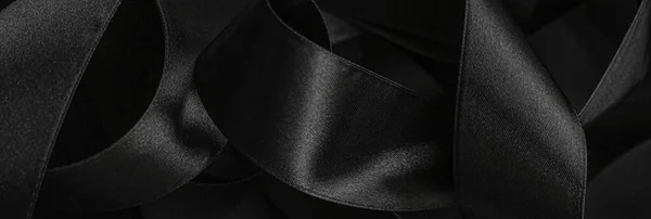 Черная шелковая лента в качестве фона, абстрактный и роскошный дизайн бренда — стоковое фото