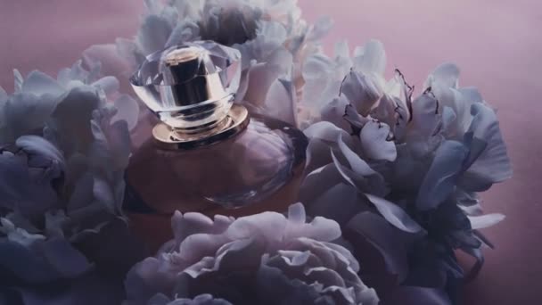 Frasco de perfume púrpura con flores de peonía, aroma de fragancia elegante como cosmético de lujo, fondo de productos de moda y belleza — Vídeos de Stock