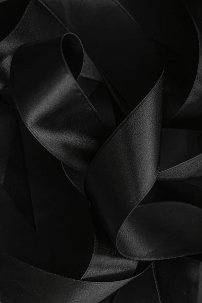 Black silk ribbon as background, abstract and luxury brand design