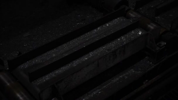 Fiery steel sweeps through black machines. Plant for the production of metal. — Stock Video