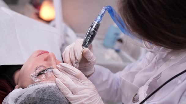 Techniek van het aanbrengen van permanente wenkbrauw make-up in een Beauty kliniek. 4k slow mo — Stockvideo