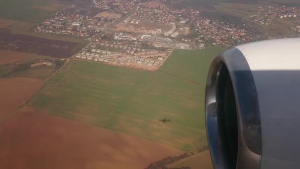 Rozpětí nad vesnicí, pod stínem letadla. Střelba z kabiny letadla. — Stock video