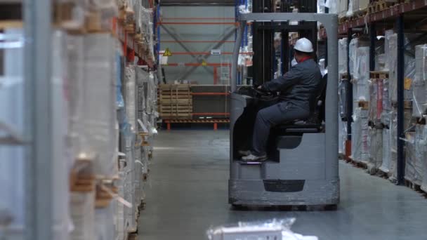 Trabajador de almacén montando una carretilla elevadora. 4K Slow Mo — Vídeos de Stock