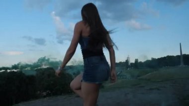 Genç kadın güzel angoo dans ayakkabı atlar, yeşil duman içinde. 4k Yavaş Mo