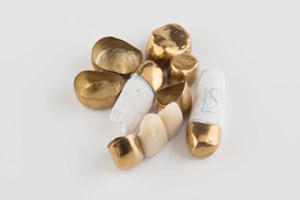 Stamped Brazed Dental Bridges Covered Gold Coated White Background — Stock Photo, Image