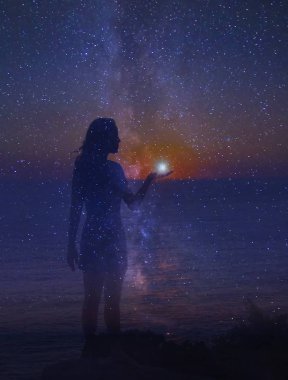 Gece gökyüzünde yıldızlar ve bir siluet duran kız ile dolu bir yıldız onun elinde. Birlik bir insan ve evren. 