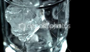 temiz su üstünde siyah izole buz küpleri ile şeffaf cam içine dökme görünümünü kapat