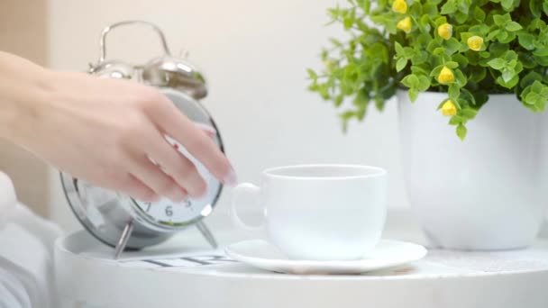 Cropped View Young Woman Taking Cup Coffee Alarm Clock Plant — Stock Video