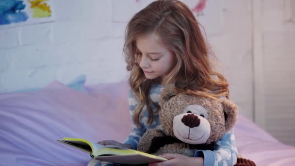 Cute Preteen Child Pajamas Sitting Bed Teddy Bear Smiling While — Stock Video
