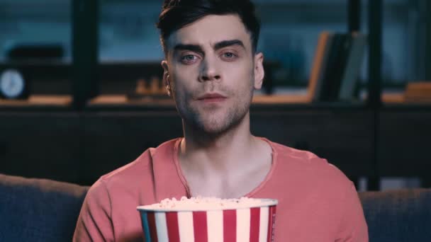 Surprised Young Man Watching While Sitting Sofa Home Holding Paper — Stock Video