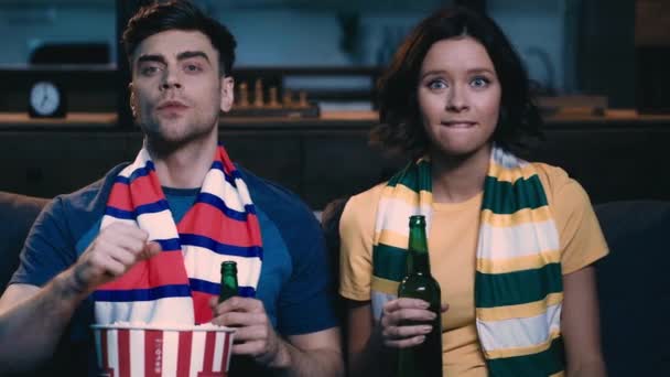 Young Man Woman Striped Scarfs Drinking Beer Eating Popcorn While — Stock Video