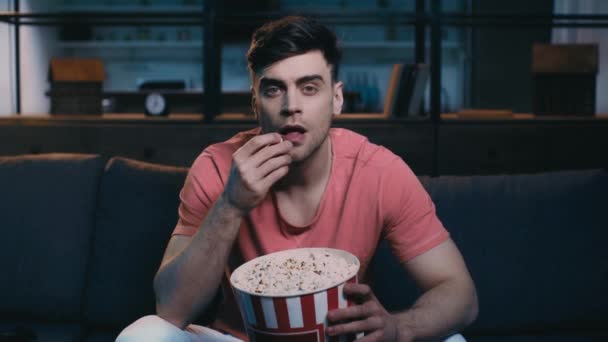 depositphotos_274344614-stock-video-attentive-young-man-eating-popcorn.jpg