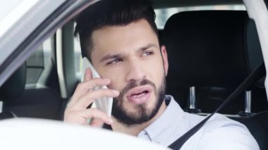 arabada oturan yakışıklı adam seçici odak, gülümseyerek ve akıllı telefon üzerinde konuşurken 