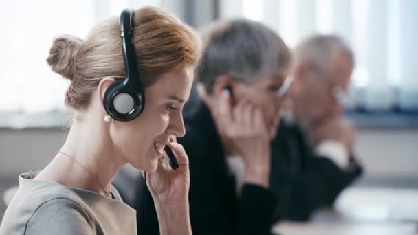 Selective Focus Attractive Woman Headset Talking While Consulting Smiling Coworkers — Stock Video