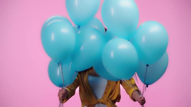 Slow Motion Beautiful Girl Hiding Balloons Looking Camera Smiling Isolated — Stock Video