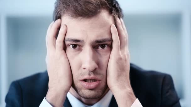 Slow Motion Shocked Businessman Holding Hands Head While Looking Camera — Stock Video