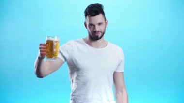 mavi bira ile cam tutan mutlu adam