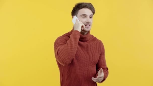 Cheerful Man Sweater Talking Smartphone Isolated Yellow — Stock Video