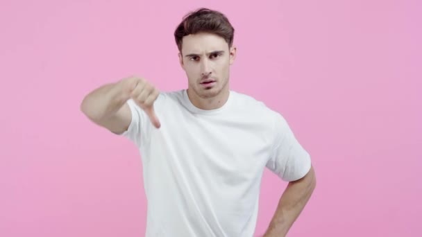 Грустный Человек Показывает Палец Вниз Изолированы Розовый — стоковое видео