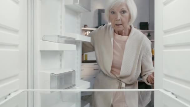 Shocked Woman Opening Closing Fridge — Stock Video