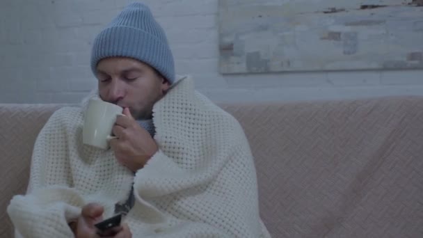 Thick Man Warm Hat Watching Drinking Warming Tea — Stock Video