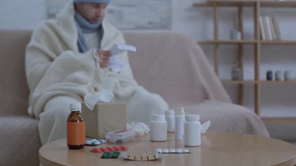 Kalın Kafalı Adam Masanın Yanında Oturmuş Elinde Ilaçlar Okuma Talimatları — Stok video