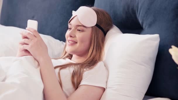 Young Woman Lying Bed Holding Smartphone — Stock Video