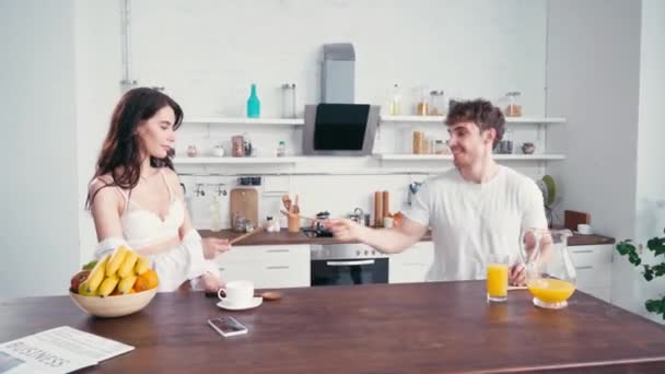 Young Couple Having Fun Spatulas Coffee Orange Juice Kitchen — Stock Video