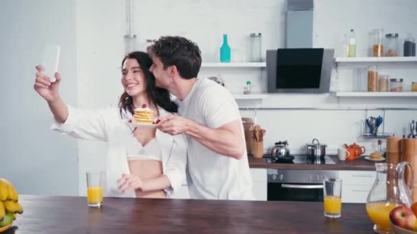 Man Pancakes Taking Selfie Embracing Sexy Woman Smartphone Home — Stock Video