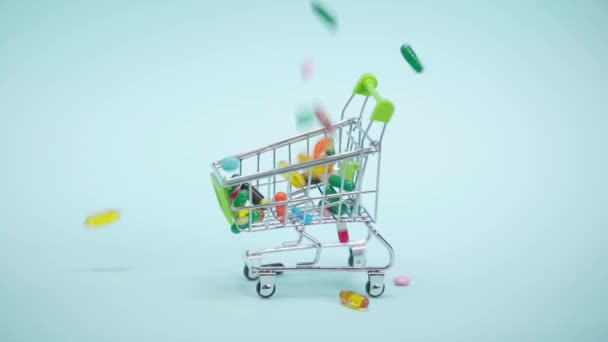 Pills Falling Small Shopping Cart Blue Background — Stock Video