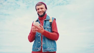 Düşük açılı turist yürüyüşü ve dışarıda müzik dinlemesi.