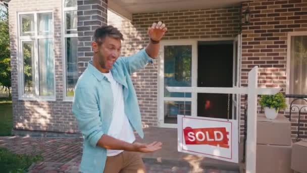 Homem Pegando Chaves Apontando Com Mão Placa Vendida Perto Casa — Vídeo de Stock