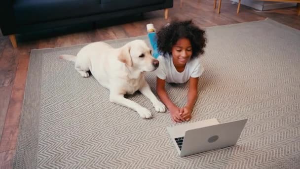 African American Girl Lying Dog Looking Laptop Carpet Home — Stock Video