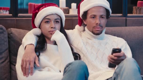 African American Man Watching Movie Scared Woman Santa Hat — Stock Video