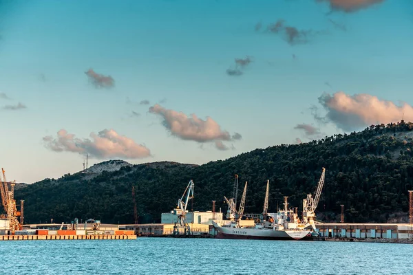 cranes in the port of Bar, Montenegro. Early morning. Fishing boats.