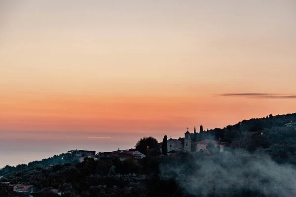Old town on the mountain. Sunset. Smoke from the chimney. Bar, Montenegro.