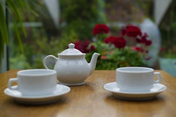 white teapot and white cups on the table