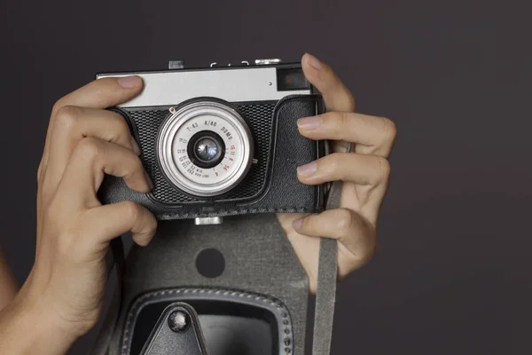 hands holding a vintage camera