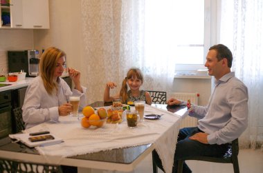 Aile masada kahvaltı ve sabah portakal suyu içmek.