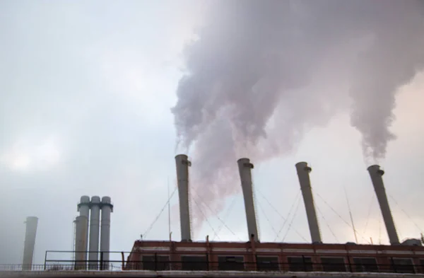 From the factory, black smoke is released into the sky. Conceptual photo about the ecology in the city.