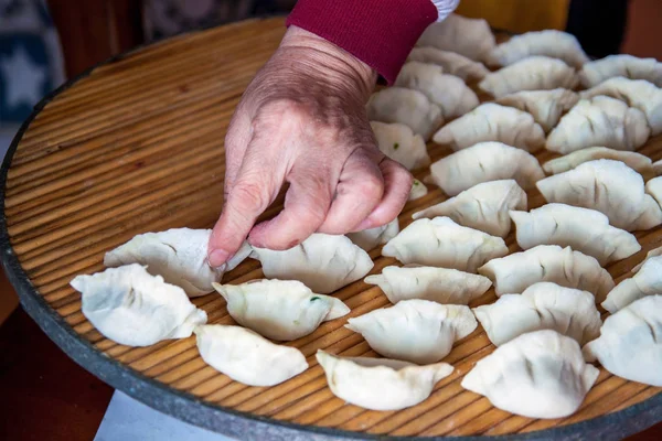 Traditional Chinese dumplings. Cooking homemade dumplings with meat and greens.
