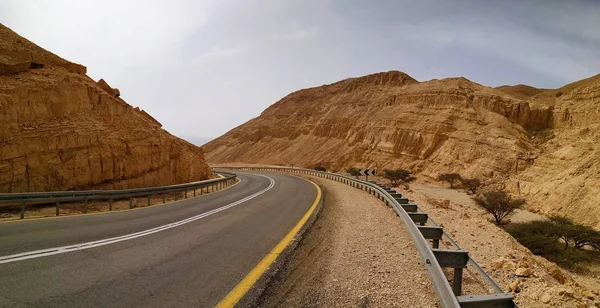 Martian landscape. Red mountains. Desolate Road Through The Desert.