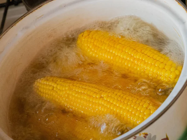 Büyük tencerede üzerinde birden çok haşlanmış mısır.