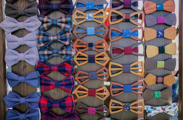 Colorful bow ties are located in the window.
