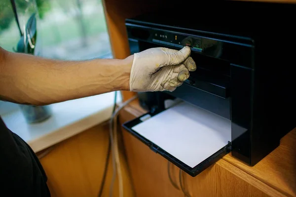 Technician hand cleaning printer toner cartridge.  used laser toner cartridge.