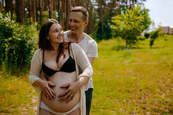 Joven Feliz Embarazada Pareja Abrazando Campo —  Fotos de Stock